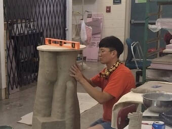 Student working on a ceramic sculpture.